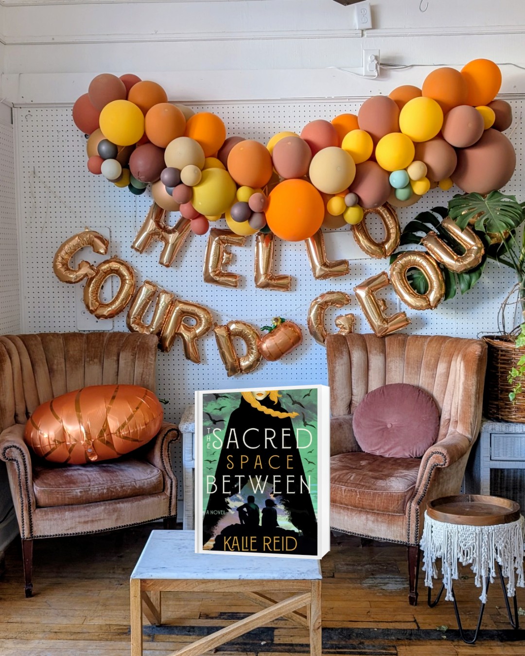 The Sacred Space Between in front of an autumn coffee shop display with balloons