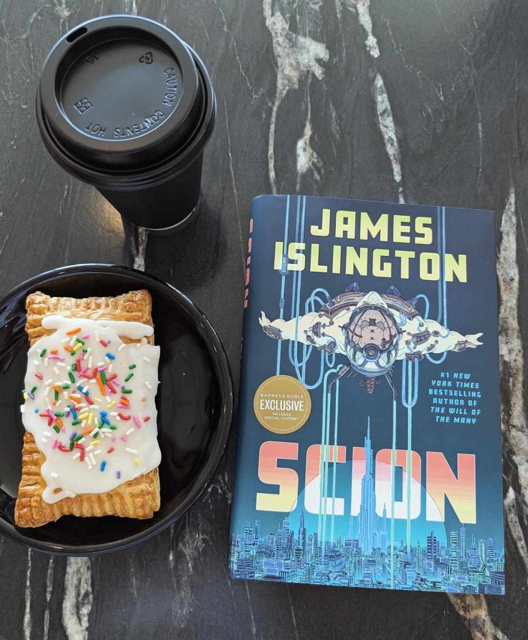 Scion by James Islington at a cafe with a pastry and tea